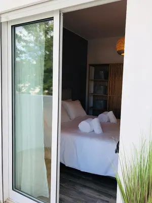 a sliding glass door leading to a bedroom with a bed at Albufeira Emblematica Apartment - Wifi & Pool in Albufeira