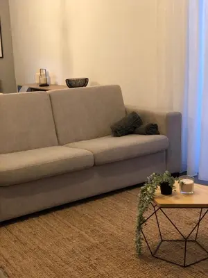 a living room with a couch and a table at Albufeira Emblematica Apartment - Wifi & Pool in Albufeira