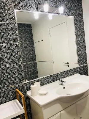 a bathroom with a sink and a mirror at Albufeira Emblematica Apartment - Wifi & Pool in Albufeira