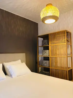 a bedroom with a bed and a book shelf at Albufeira Emblematica Apartment - Wifi & Pool in Albufeira