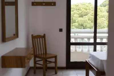 a room with a chair and a desk and a window at Vila de Santa Eulália - Albufeira in Albufeira