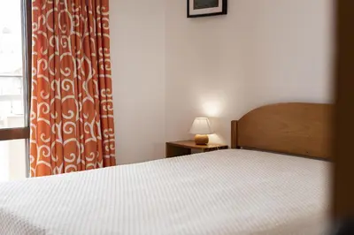a bedroom with a bed and a window at Vila de Santa Eulália - Albufeira in Albufeira