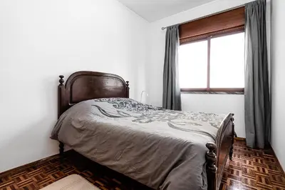 a bedroom with a bed and a window in it at Casa Bela in Faro