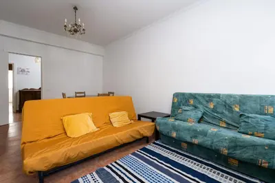 a living room with a couch and a bed at Casa Bela in Faro