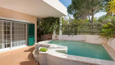 a swimming pool in the backyard of a house at Joanne in Vale do Lobo