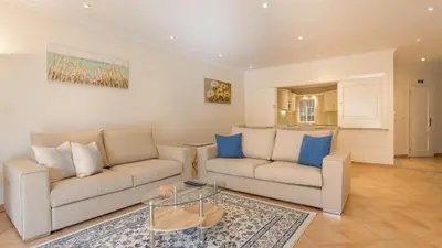 a living room with two couches and a table at Joanne in Vale do Lobo