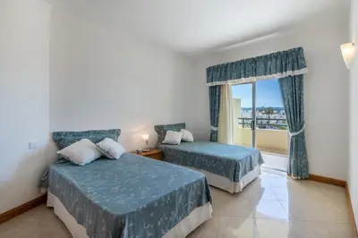 a hotel room with two beds and a window at AL - Maré in Albufeira