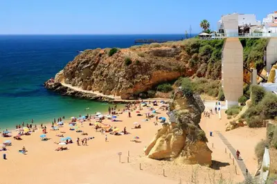 a building on a beach next to the ocean at Bright apartment with sea view in Albufeira - 62 m², Pool in Albufeira