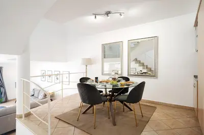 a dining room with a table and chairs at Casa Maya - Vale do Garrão in Quinta do Lago
