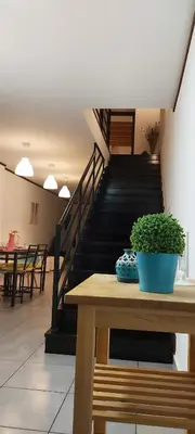 a potted plant sitting on a wooden table with a staircase at Casa Senhora da Ria- localização perfeita em Faro in Faro