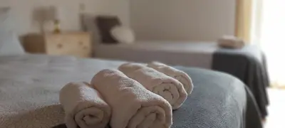 a group of towels sitting on top of a bed at Casa Senhora da Ria- localização perfeita em Faro in Faro