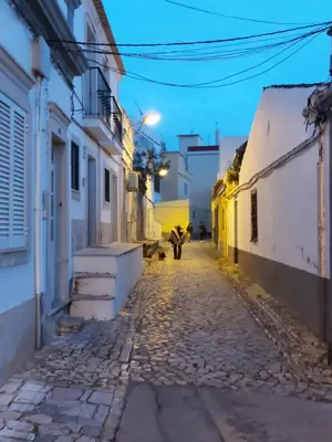 a street in an alley at night at Casa Senhora da Ria- localização perfeita em Faro in Faro