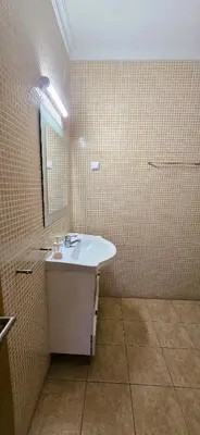 a bathroom with a sink and a mirror at Odete Túnel - Albufeira in Albufeira