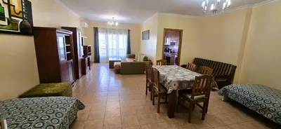 a room with a table and chairs and a living room at Odete Túnel - Albufeira in Albufeira
