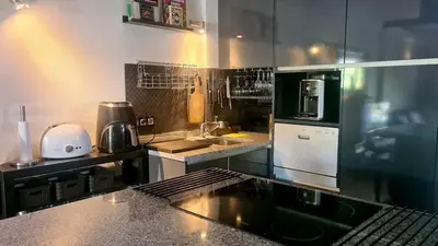 a kitchen with a sink and a counter top at Cozy Garden T1 near the beach in Albufeira