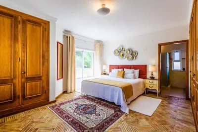 a bedroom with a bed and a large window at Endless Summer Luxury Villa in Quinta do Lago