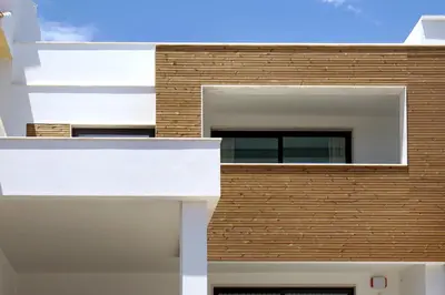 a facade of a building with white and wood at Villa Ocean Marina, Panoramic and heatable Pool by DreamvillasAlbufeira in Albufeira