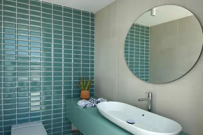 a bathroom with a sink and a mirror at Villa Ocean Marina, Panoramic and heatable Pool by DreamvillasAlbufeira in Albufeira