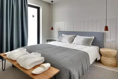 a bedroom with a large bed with towels on a table at Villa Ocean Marina, Panoramic and heatable Pool by DreamvillasAlbufeira in Albufeira