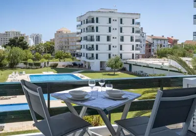 a table with wine glasses on a balcony with a view at Aldeia do Mar Studio Vilamoura Center - SWIMMING POOL in Vilamoura