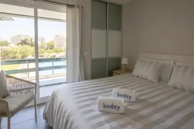 a bedroom with a bed with two white pillows on it at Aldeia do Mar Studio Vilamoura Center - SWIMMING POOL in Vilamoura