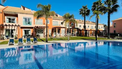 a large swimming pool with chairs and palm trees at Santa Maria N by Check-in Portugal in Albufeira