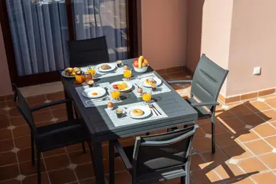 a table with plates of food and fruit on it at Villa Simone by Intiholidays in Quarteira
