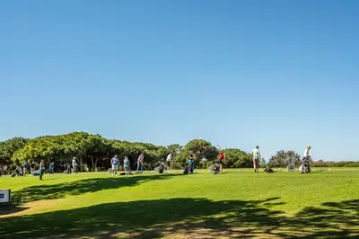 a group of people walking in a park at Villa Simone by Intiholidays in Quarteira