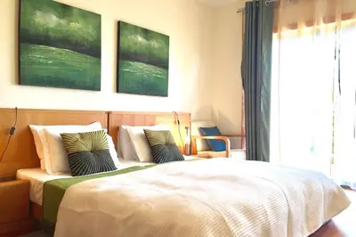 a bedroom with a large bed with two pillows at Albufeira parque da CORCOVADA standing flat W/Pool in Albufeira