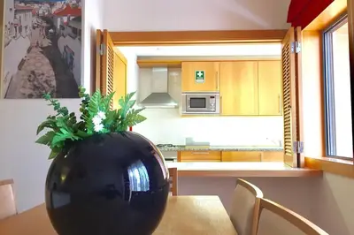 a black vase sitting on a table in a kitchen at Albufeira parque da CORCOVADA standing flat W/Pool in Albufeira