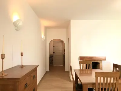 a kitchen and dining room with a table and chairs at Albufeira + appartement proche plage avec piscine in Albufeira