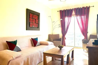 a living room with a couch and a table at Albufeira l AMAZING terrasse with jacuzzi Encosta da Orada in Albufeira
