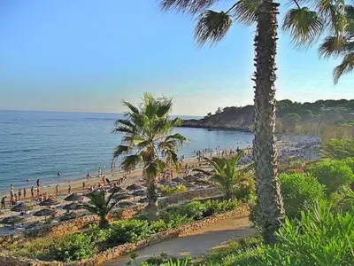 a beach with palm trees and a group of people at V4, Villa Jardins Branqueira2 near Beach, Albufeira in Albufeira