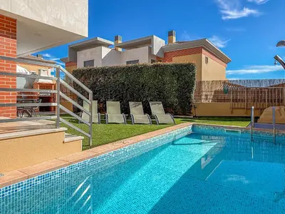 a large blue swimming pool in front of a building at V4, Villa Jardins Branqueira2 near Beach, Albufeira in Albufeira