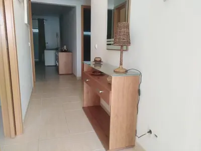 a lamp on a wooden dresser in a room at Salgados Sea View Apartment in Albufeira