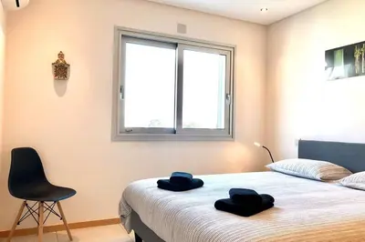 a bedroom with a bed with two towels on it at Falesia beach l roof top pool in Albufeira