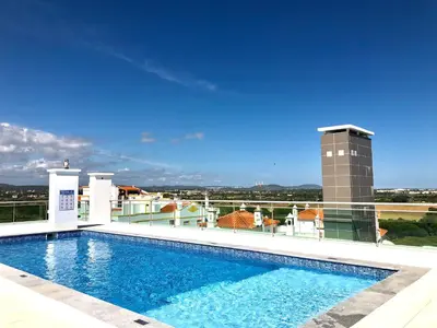 a swimming pool on the roof of a building at Falesia beach l roof top pool in Albufeira