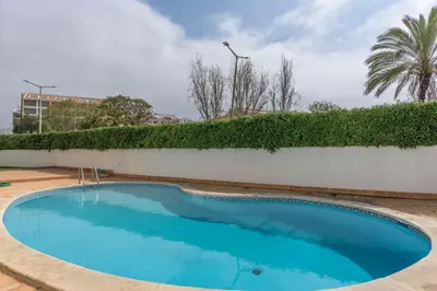 an empty swimming pool in front of a wall at FLH Albufeira Balcony Flat with Pool in Albufeira