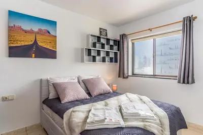 a bedroom with a bed and a window at FLH Albufeira Balcony Flat with Pool in Albufeira