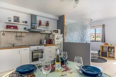 a kitchen with a table with wine glasses on it at FLH Albufeira Balcony Flat with Pool in Albufeira