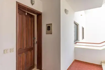 an empty room with a wooden door and a window at FLH Albufeira Balcony Flat with Pool in Albufeira