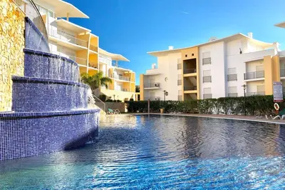 a swimming pool in front of some apartment buildings at Albufeira l encosta da Orada wonderful sea view in Albufeira