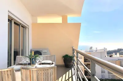 a balcony with a table and a view of the ocean at Albufeira l encosta da Orada wonderful sea view in Albufeira