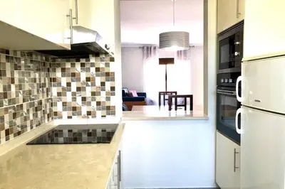 a kitchen with a white refrigerator and a counter top at Poente da Aldeia apartment in Albufeira