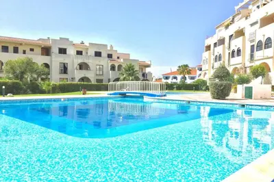 a large swimming pool in front of some buildings at Poente da Aldeia apartment in Albufeira