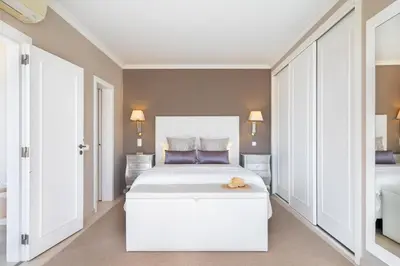a bedroom with a large white bed with a teddy bear on it at WHome | Prime Hideaway Luxury Villa in Quarteira