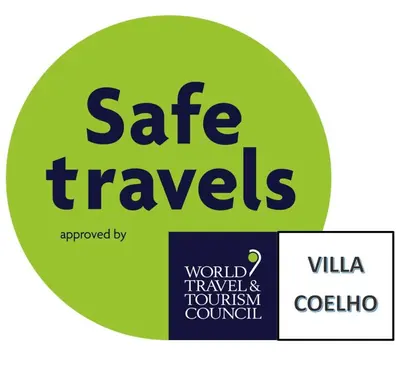 a green circle with the words safe travels and the world travel tourism council at VILLA COELHO in Albufeira