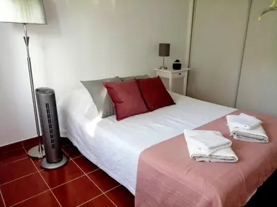 a bedroom with a white bed with red pillows at Pool and Garden Village-near beach in Albufeira