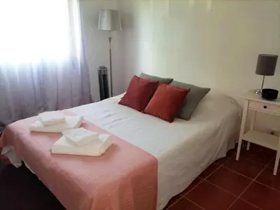 a bedroom with a bed with two towels on it at Pool and Garden Village-near beach in Albufeira