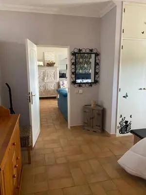 a room with a living room with a television on the wall at Casa da azinheira in Loulé